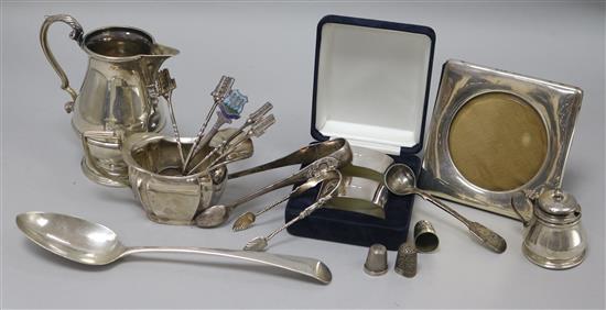 Two silver cream jugs, a cased pair of silver napkin rings and other items including flatware and photograph frame.
